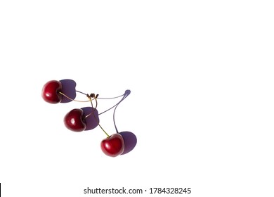 Three sweet cherries on white background. Copy space. Illustration of fake friendship. Cherries are connected only on shadow. In real life these are three separate berries. Hard strong shadows. - Powered by Shutterstock