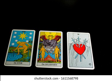 Three Tarot Cards With Black Background