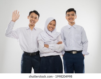 Three teenagers in junior high school uniforms smiling with say hello gesture when standing on an isolated background - Shutterstock ID 1998204998