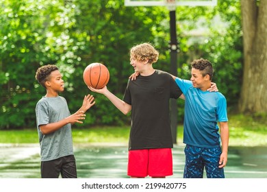 The Three Teens Friends In Sportswear Playing Basketball Game