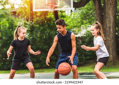 The three teens in sportswear playing basketball game - Powered by Shutterstock