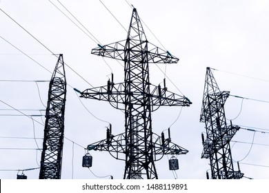 Three Terminal Pylons Of Power Lines With Wires Stretched In Different Directions, Transition From Overhead To Underground Cable Lines