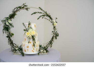 Three Tier Wedding Cake With Gold Leaf And Fresh Flowers