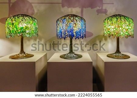 Three Tiffany table lamps with blue and green shades

