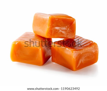 three toffee caramel candies close-up isolated on white background 

