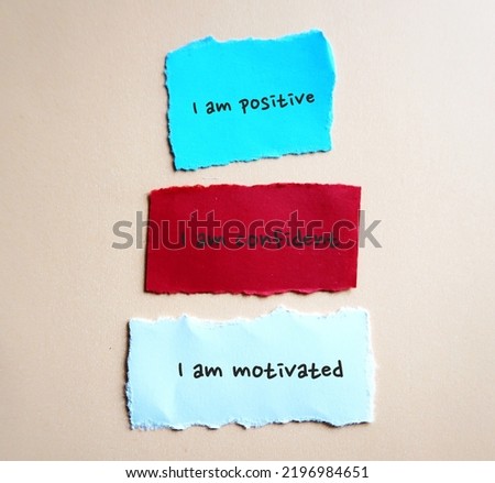 Three torn note on background with handwritten text I AM POSITIVE, I AM CONFIDENT, I AM MOTIVATED - powerful self talk positive affirmations to boost self confidence in daily life