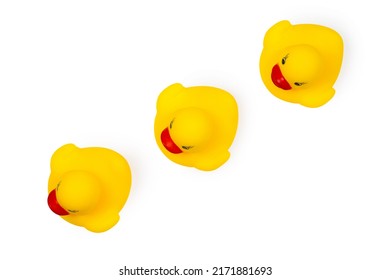 Three Toy Ducklings In A Row On A White Background. View From Above. Toy Ducks For Children.