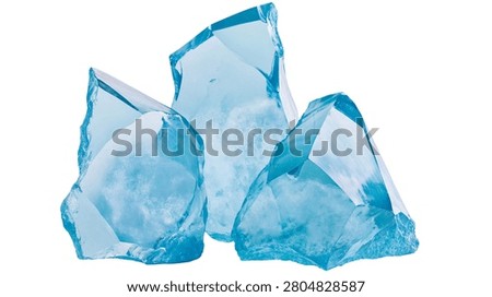Three translucent light blue glass rocks with jagged edges and rough textures