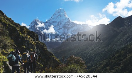 Three Trekkers Walking on Everest Highway While Seeing Mount Ama Dablam, Everest Base Camp Trek From Tengboche to Dingboche , Nepal