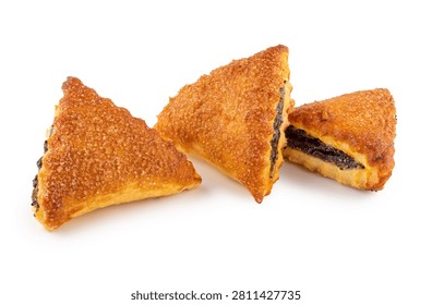 Three triangle puff pastry turnovers filled with black poppy seed paste and sprinkled with sugar crystals, isolated on white background.