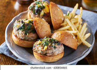 Three Turkey Burger Sliders With Fries On Plate            