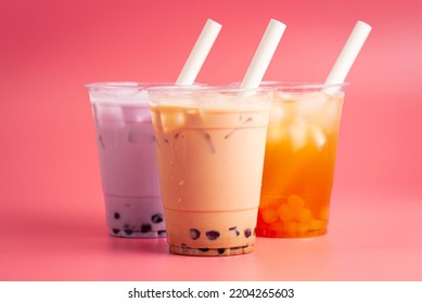 Three Types Of Boba Tea On A Pink Background