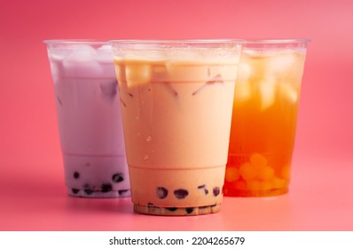 Three Types Of Boba Tea On A Pink Background