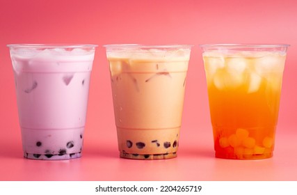 Three Types Of Boba Tea On A Pink Background