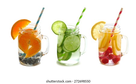 Three types of fruit filled detox water mason jars with straws isolated on a white background - Powered by Shutterstock