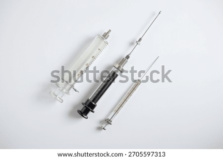 Three types of glass syringes for sample injection in HPLC and instrumental analysis, including 100 microliter, 10 mL, and 20 mL syringes, on a white background.