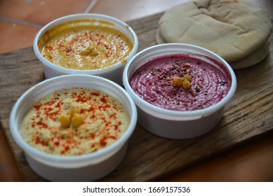 Three Types Of Hummus With Whole Wheat Pita Bread