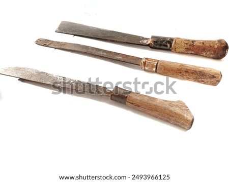 Three types of old rusty machetes isolated on a white background. old antique machete. In Indonesia, this tool is called a "parang" and its function is to split coconuts, split bamboo