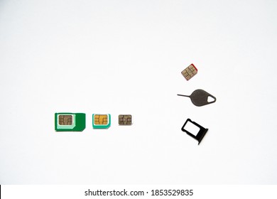 three types of SIM cards with adapters: Microsim, mini SIM, nano SIM. a key and a slot for a SIM. on white background.