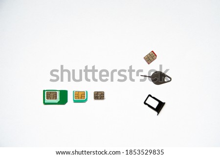 three types of SIM cards with adapters: Microsim, mini SIM, nano SIM. a key and a slot for a SIM. on white background.