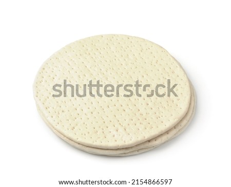 Three uncooked frozen pizza dough bases isolated on white