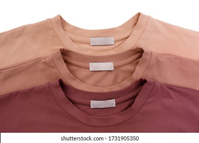 Three Unisex Basic Blank T-shits In Pastel Colors Isolated On White Background. Top View. Capsule Wardrobe Concept. Creative Flat Lay. Minimal Style. Pattern. Trendy Clothes Collage.