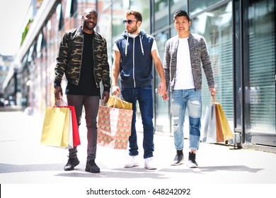 Three urban guys shopping and laughing-multiple ethnicity  - Shutterstock ID 648242092