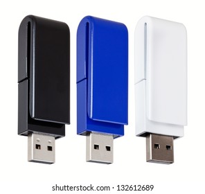 Three USB flash drives of different colors isolated on white