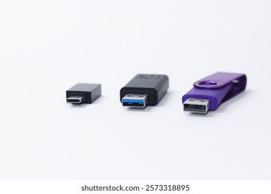 Three USB Flash drives with different technologies on white background. USB type-C, Micro-USB, USB 2.0 and 3.0 devices, pendrive with Gigabites of capacity GB sstkTechnology