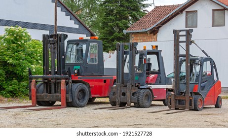 Three Used Red Forklift Tuck Vehicles Outside