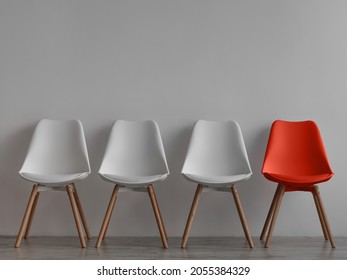 Three vacant white chairs and one red on gray wall background in office or room. Simple minimalist interior, nobody, free space. Job recruiting, leadership and business due covid-19 virus, mockup - Shutterstock ID 2055384329