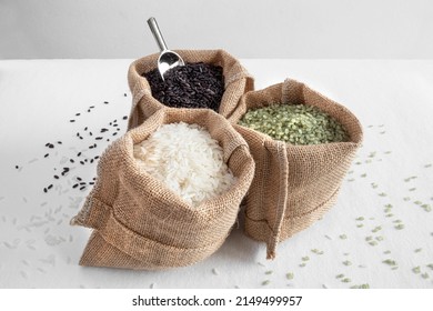 Three Varieties Of Rice, Green, White And Black, In Hessian Bags