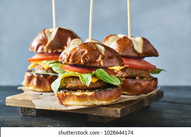 three vegan burger sliders with pretzel buns - Powered by Shutterstock