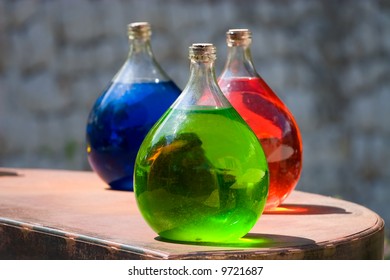 Three vesseles with colored liquid.