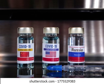 Three Vials Of Vaccine Covid-19 Vaccine With A Flag Label Of USA, China, Russia. Coronavirus Concept.