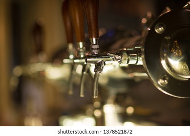 Three Vintage Golden Beer Taps In The Bar, Blurry Background. Detail On Beer Faucet.