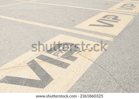 three vip pro writing caption text parking spaces spots next to each other in parking lot outside exterior outdoors under sunshine in yellow and black