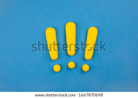 Three vivid exclamation marks on blue background.  Keep attention concept,  importance background, warning.