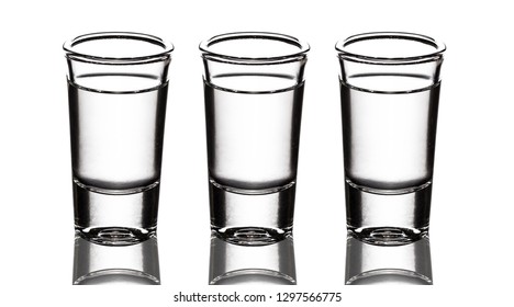 Three Vodka Shot Glass Row Isolated On White.