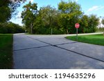 A three way intersection with stop sign in Case Eagle Park within a slow speed area of the Rochester Wisconsin Park. 