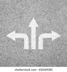 Three ways crossroad direction sign on asphalt concrete road.