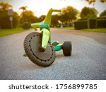 Child’s three wheeler . Big wheel toy in the road. tricycle with plastic wheels. Classic vintage childhood big wheeler. Traditional tricycle