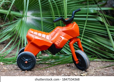 Child’s Three Wheeler . Big Wheel Toy In The Road. Motorcycle With Plastic Wheels. Bike Plastic Toys For Kids On The Playground On A Sunny Day