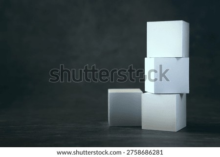 Three white cardboard boxes on a dark background. Mock up,