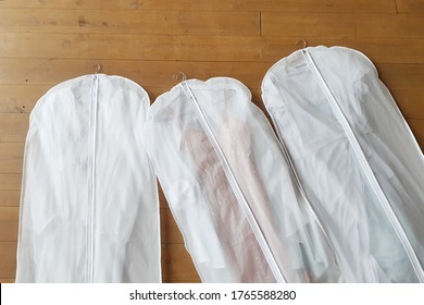 Three White Hanging Garment Bag On The Floor. The Morning Before The Wedding. Pack Your Things On A Trip Or Sort And Hang Up Your Wardrobe.