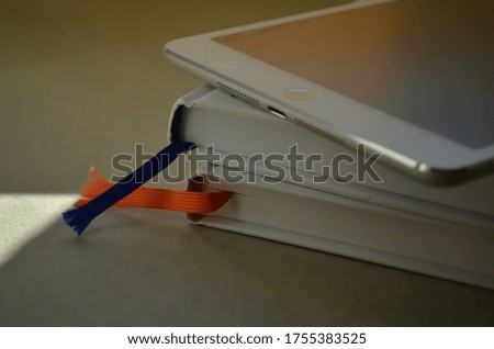 three white objects two books one device 