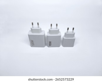 Three white power adapters with different wattage ratings (120W, 90W, and blank) arranged on white background. Ideal for electronics or charging accessories themes.
