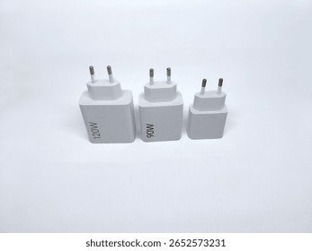Three white power adapters with different wattage ratings (120W, 90W, and blank) arranged on white background. Ideal for electronics or charging accessories themes.

