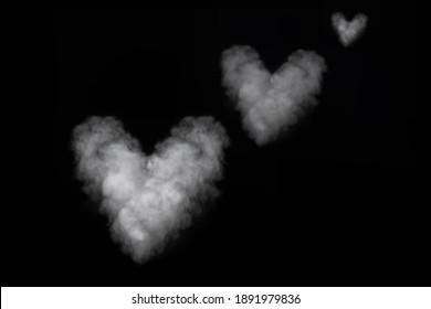 Three white smoke heart shape isolated on black background. Curly smoke for Valentine's Day on a dark background. Abstract background, design element