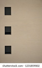 three windows of a building with a brick facade in Vitoria-Gasteiz (Spain)